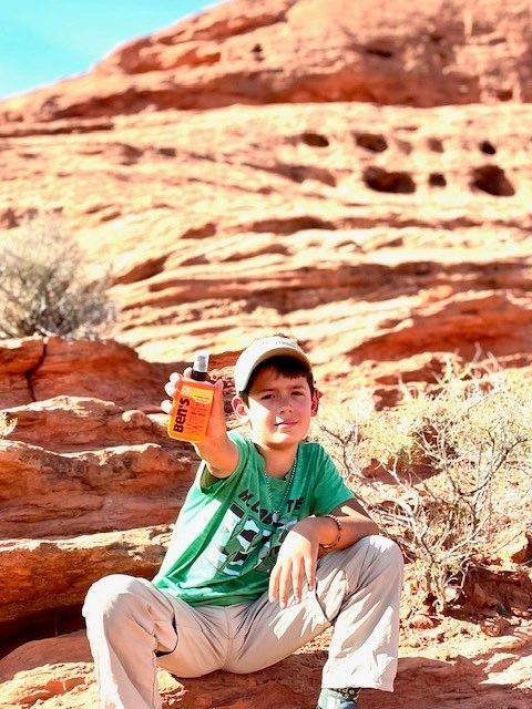 Mike holding Ben's insect repellent in the red rocks